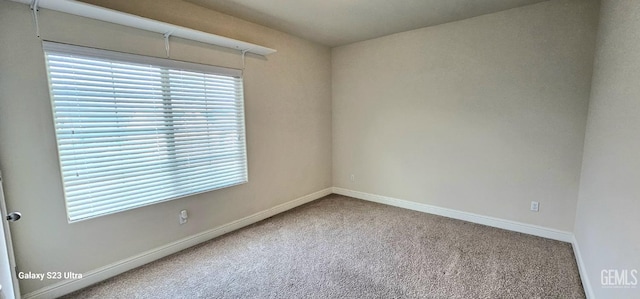 carpeted empty room featuring plenty of natural light