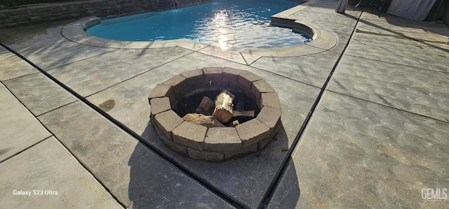 details featuring an outdoor fire pit and a swimming pool