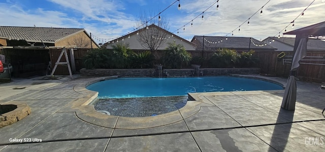 view of swimming pool featuring pool water feature and a patio area