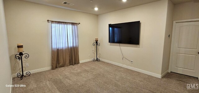 empty room featuring light carpet