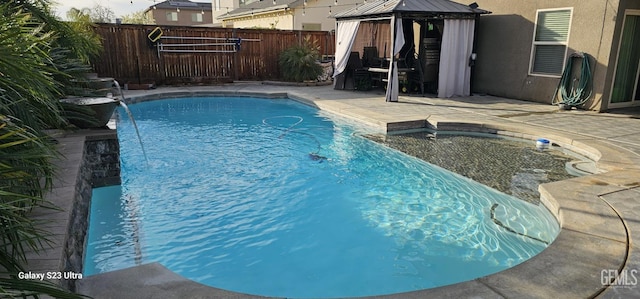 view of swimming pool featuring a gazebo, pool water feature, and a patio