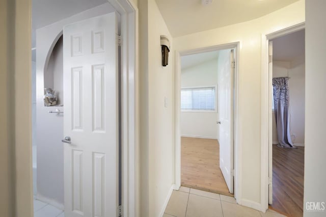 corridor featuring light tile patterned floors