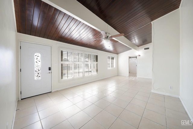 entryway with light tile patterned flooring, vaulted ceiling, wooden ceiling, ceiling fan, and a barn door