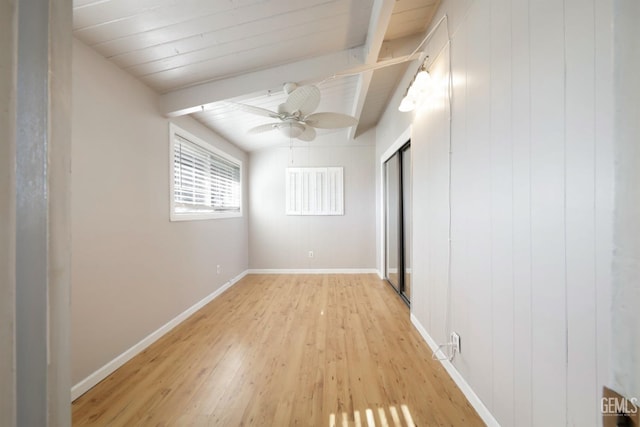 unfurnished bedroom featuring wood ceiling, light hardwood / wood-style flooring, ceiling fan, lofted ceiling with beams, and a closet