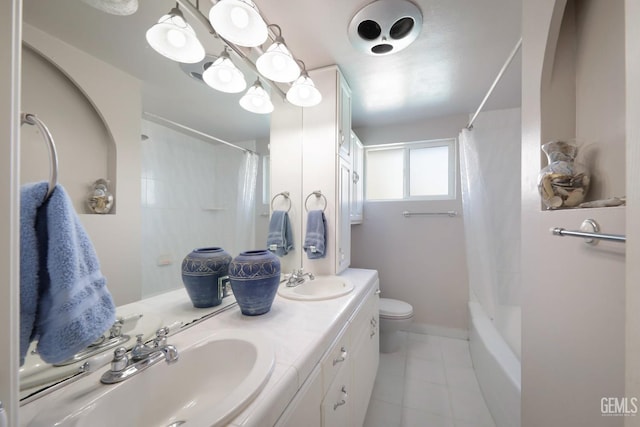 full bathroom featuring vanity, tile patterned floors, shower / bath combo with shower curtain, and toilet