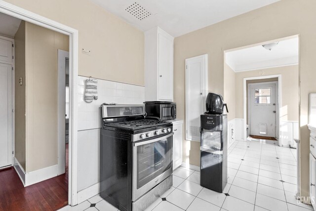 interior space with light tile patterned floors and white cabinets