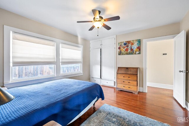 bedroom with wood-type flooring and ceiling fan