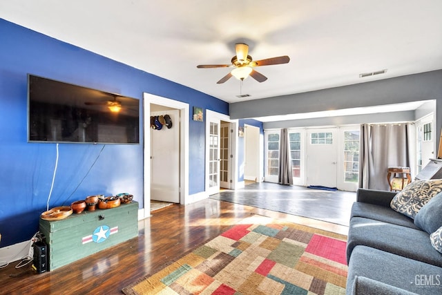 living room featuring wood-type flooring, french doors, and ceiling fan