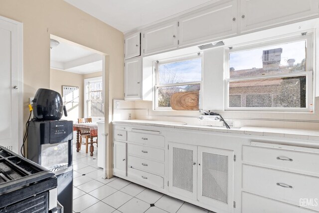 bathroom featuring tile patterned flooring and decorative backsplash