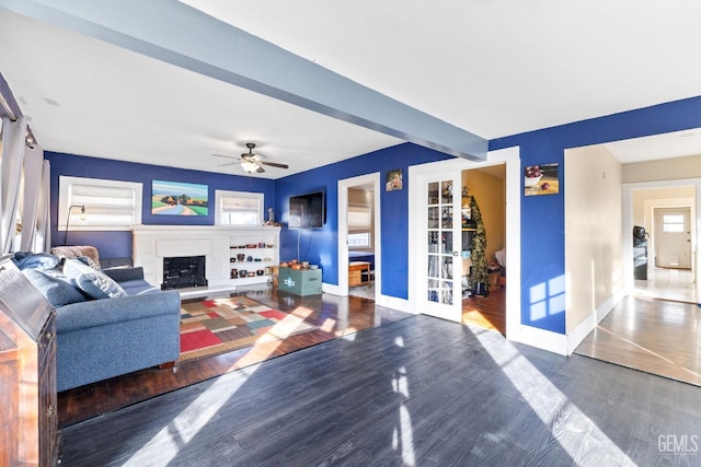 living room with dark hardwood / wood-style flooring, beam ceiling, french doors, and ceiling fan