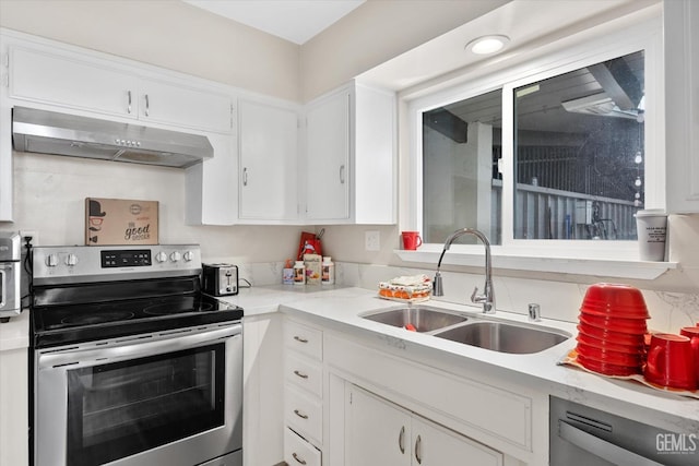 941 Panorama Dr, Bakersfield, CA 93305 - kitchen with electric range, under cabinet range hood, white cabinets, dishwashing machine, and light countertops