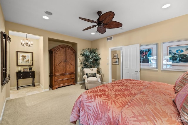 carpeted bedroom featuring ceiling fan with notable chandelier