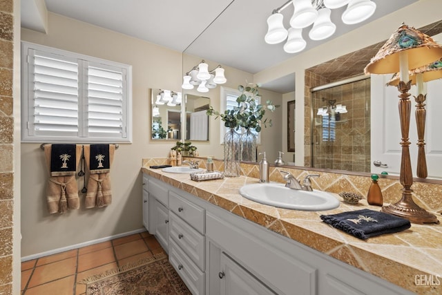 bathroom featuring tile patterned flooring, vanity, and an enclosed shower