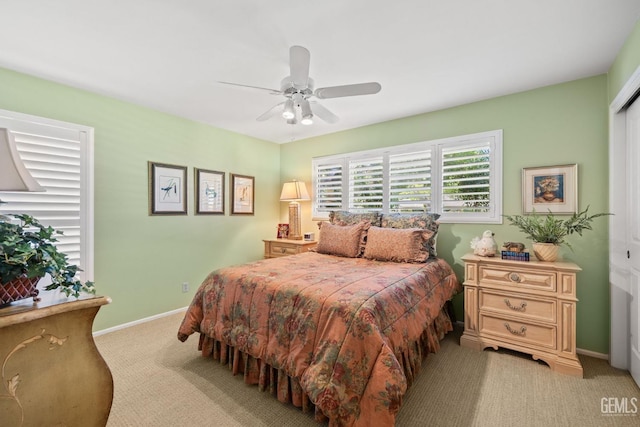 bedroom featuring ceiling fan and light carpet