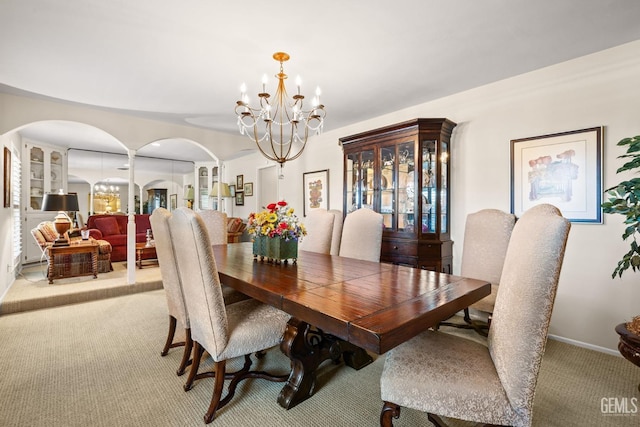 dining room with light carpet and an inviting chandelier