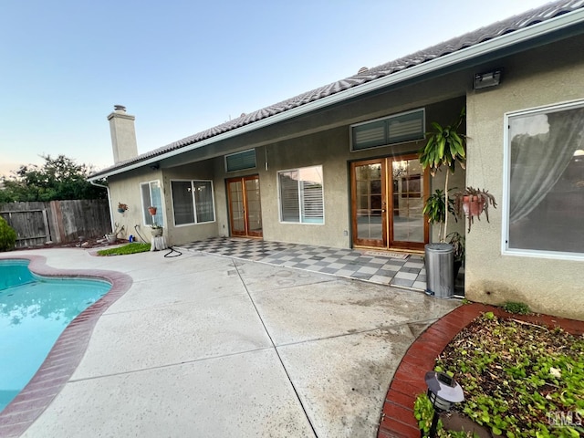 3205 Petite Sirah St, Bakersfield, CA 93306 - back of property with french doors, a patio, a chimney, and stucco siding