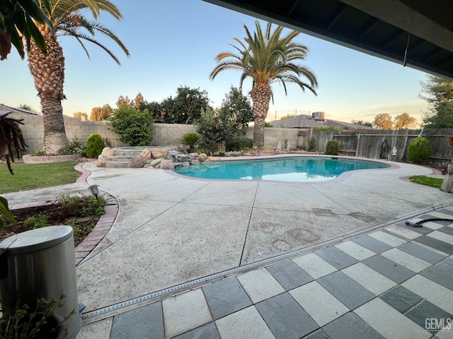 3205 Petite Sirah St, Bakersfield, CA 93306 - pool at dusk featuring a fenced backyard and a patio