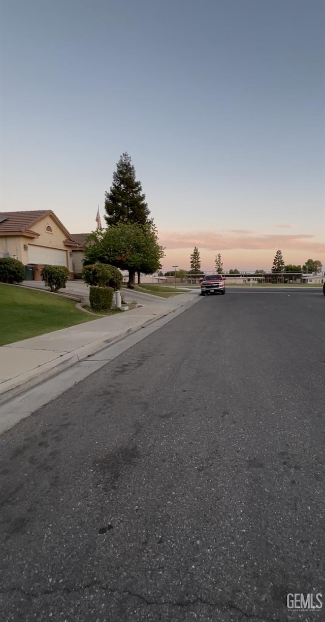 3205 Petite Sirah St, Bakersfield, CA 93306 - view of asphalt road with curbs and sidewalks