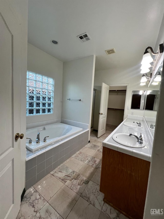 3205 Petite Sirah St, Bakersfield, CA 93306 - bathroom with a bath, double vanity, a shower stall, and a closet