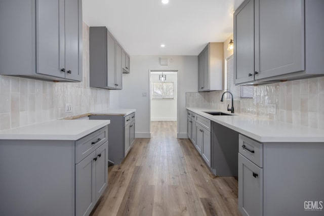 1813 6th Ave, Delano, CA 93215 - kitchen featuring gray cabinetry, a sink, tasteful backsplash, and recessed lighting