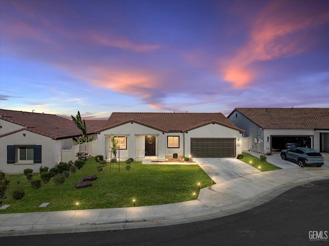7305 Scrivia Ct, Bakersfield, CA 93311 - view of front facade featuring an attached garage, a tile roof, stucco siding, and driveway