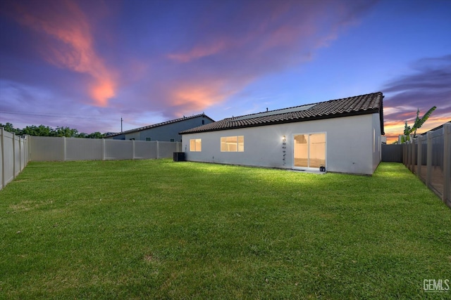7305 Scrivia Ct, Bakersfield, CA 93311 - back of property at dusk with stucco siding and central AC unit