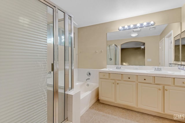 bathroom with vanity, tile patterned flooring, and plus walk in shower