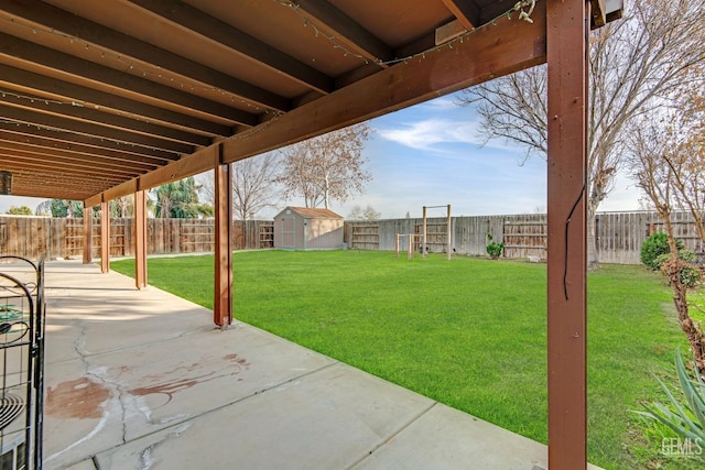 view of yard with a storage unit and a patio area