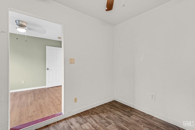 empty room with hardwood / wood-style floors and ceiling fan