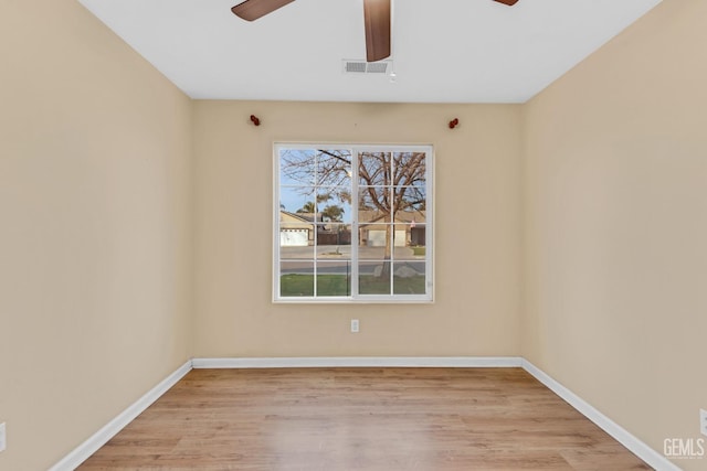 spare room with light hardwood / wood-style flooring and ceiling fan