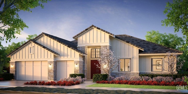 modern inspired farmhouse with an attached garage, stone siding, and board and batten siding