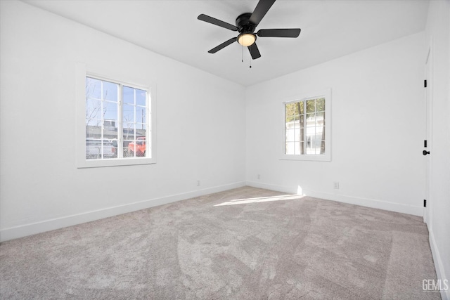 carpeted empty room featuring ceiling fan