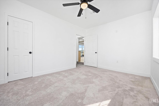 unfurnished room with ceiling fan and light carpet