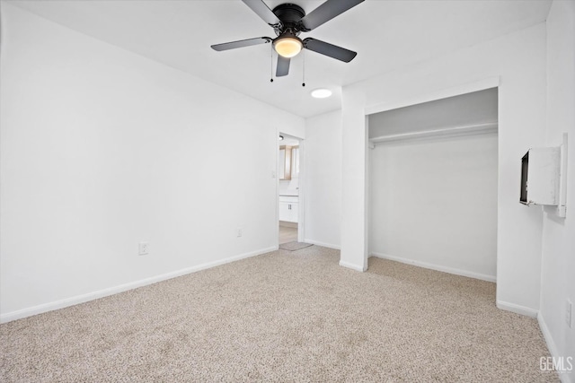 unfurnished bedroom with light colored carpet, ceiling fan, and a closet