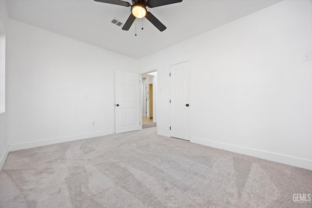 unfurnished room featuring light colored carpet and ceiling fan