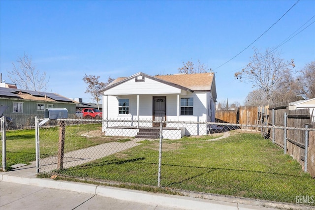 bungalow-style house with a front yard and covered porch