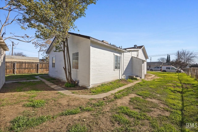 view of home's exterior with a lawn