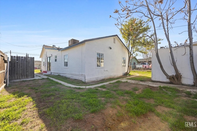 view of side of property featuring a yard