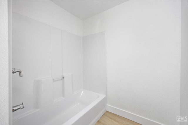 bathroom with a bath and wood-type flooring