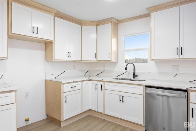 kitchen with sink, white cabinets, dishwasher, light stone counters, and light hardwood / wood-style flooring