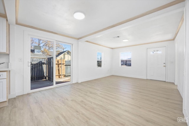 unfurnished living room featuring light hardwood / wood-style floors and crown molding