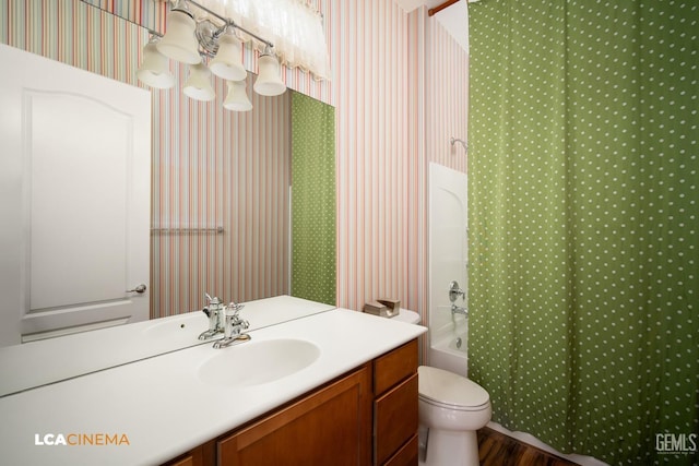 full bath featuring toilet, shower / bath combination with curtain, vanity, and wallpapered walls