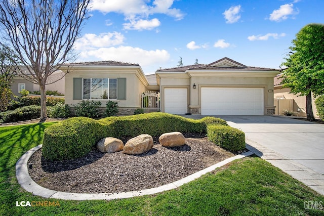 view of front of home with stucco siding, stone siding, fence, concrete driveway, and an attached garage