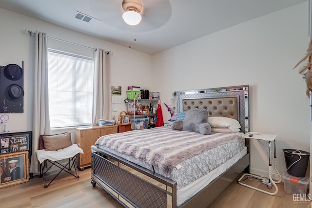 bedroom with visible vents, ceiling fan, and wood finished floors