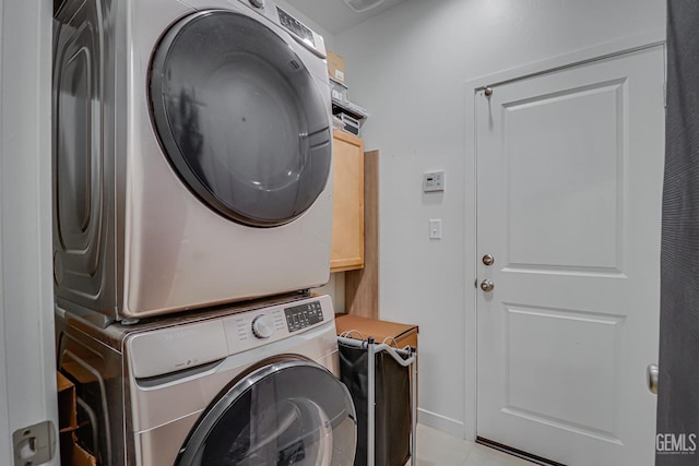 clothes washing area featuring laundry area and stacked washer and clothes dryer