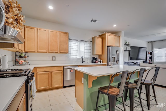 kitchen featuring a sink, visible vents, appliances with stainless steel finishes, and light brown cabinets