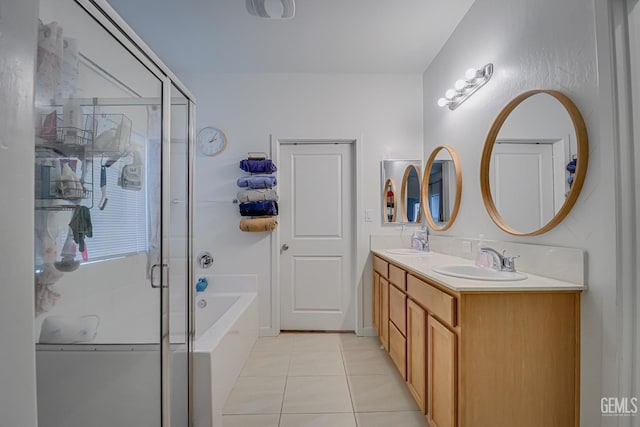 full bath featuring a sink, a shower stall, and tile patterned floors