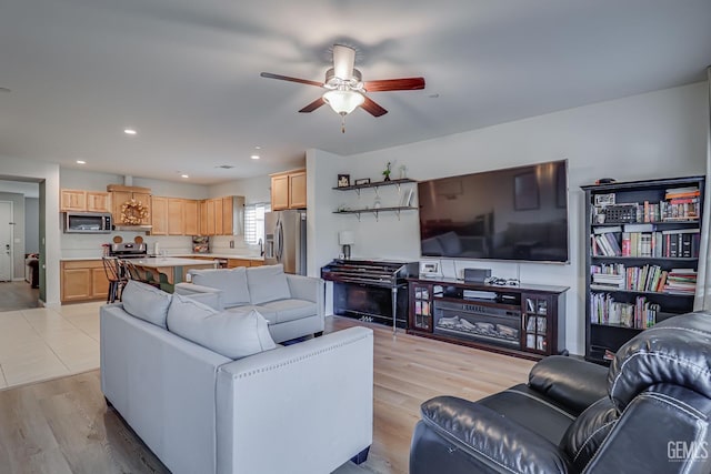 living area with recessed lighting, light wood-style floors, and ceiling fan