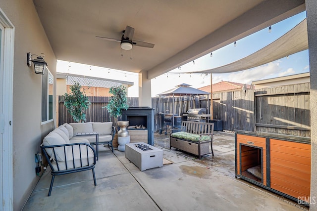 view of patio featuring an outdoor living space with a fire pit, grilling area, fence, and ceiling fan