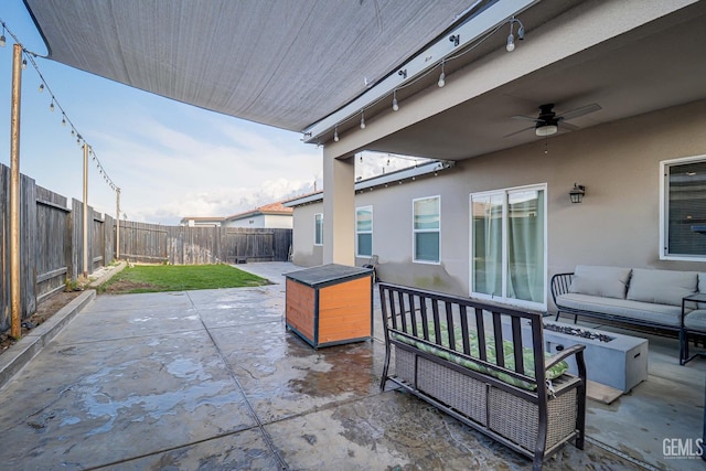 view of patio / terrace with a ceiling fan, an outdoor living space, and a fenced backyard